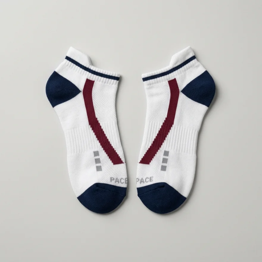 A pair of custom white ankle socks with navy heel and toe, a burgundy stripe and a woven PACE logo