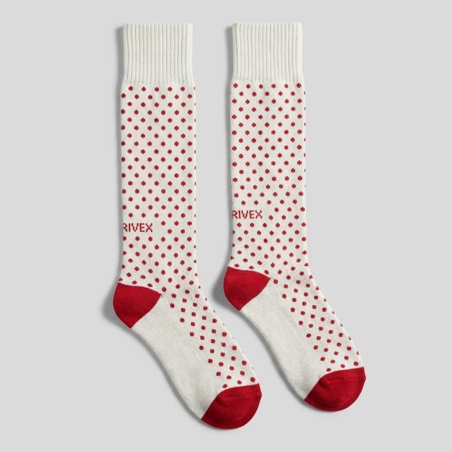 A pair of custom cream below-knee socks with a red polka-dot pattern, red heel and toe, and a woven RIVEX logo