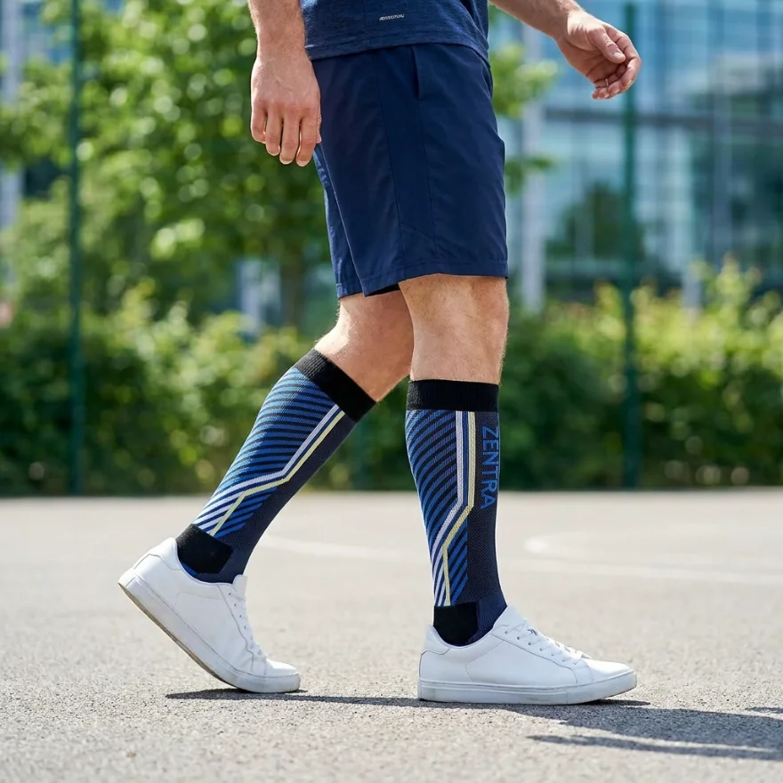 Custom navy and blue striped athletic below-knee socks with a ZENTRA logo, worn while walking