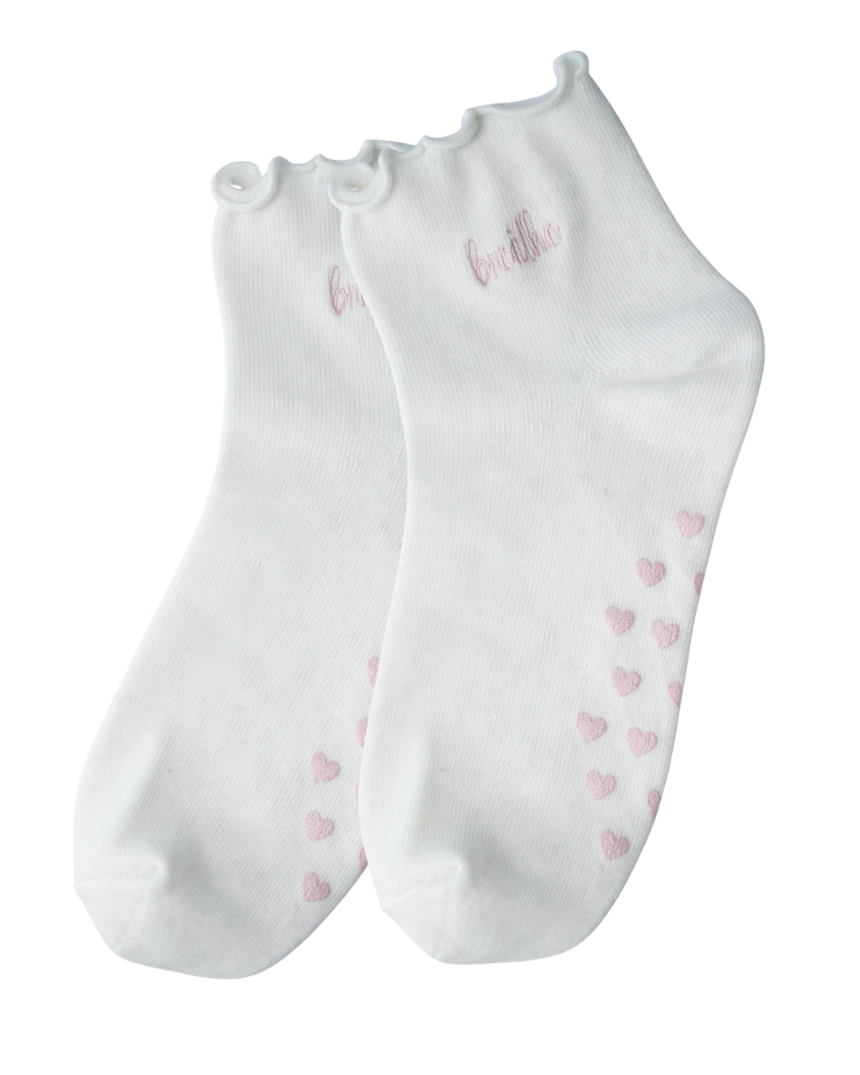 Custom white ankle socks with a pink 'breathe' embroidery and heart pattern