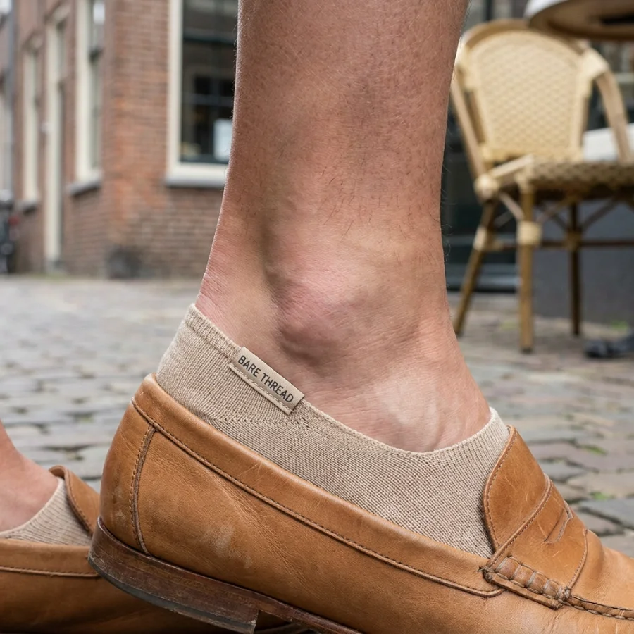Custom beige no-show socks with a BARE THREAD tab, worn with tan leather loafers